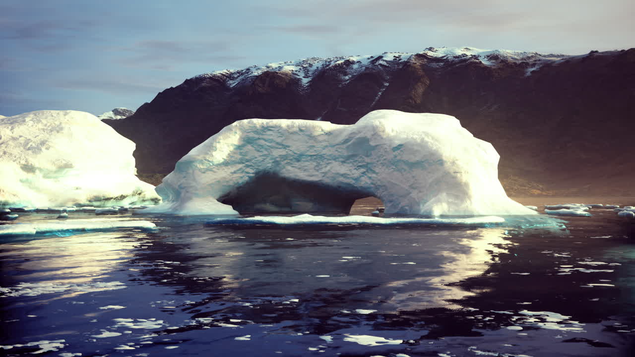 Majestic ice arch formation surrounded by tranquil waters in remote landscape