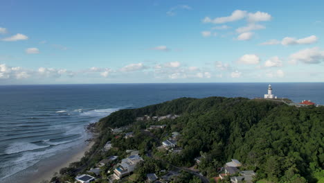 byron bay with lighthouse and coastline under a clear blue sky, aerial view