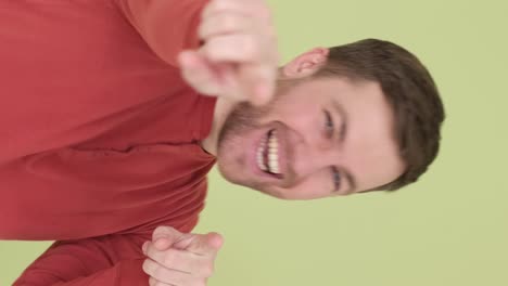 happy australian man dancing in studio background handsome man shows satisfied emotions happy australian man dancing in studio background a handsome man on a green background expresses satisfied emotions