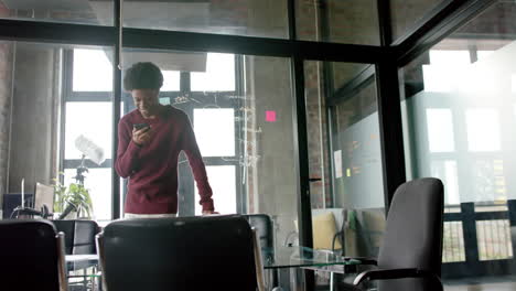 african american casual businessman talking on smartphone at home office, slow motion, copy space