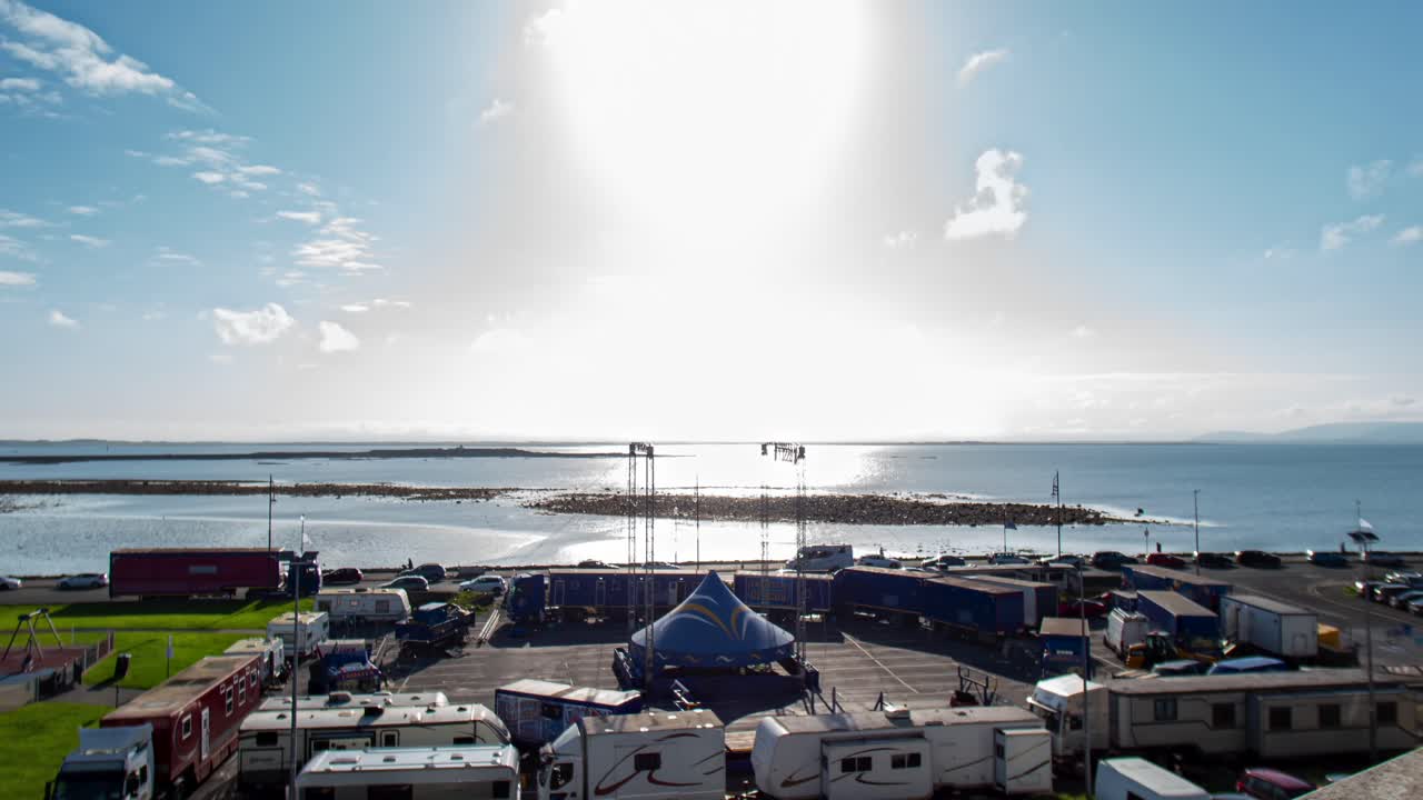 Circus by the Sea: Aerial View of a Circus Setup on a Coastal Parking Lot