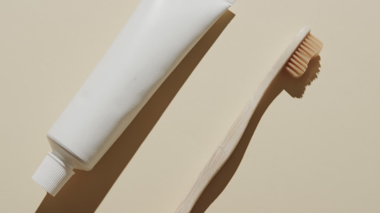 Close up of toothbrush and toothpaste on beige background