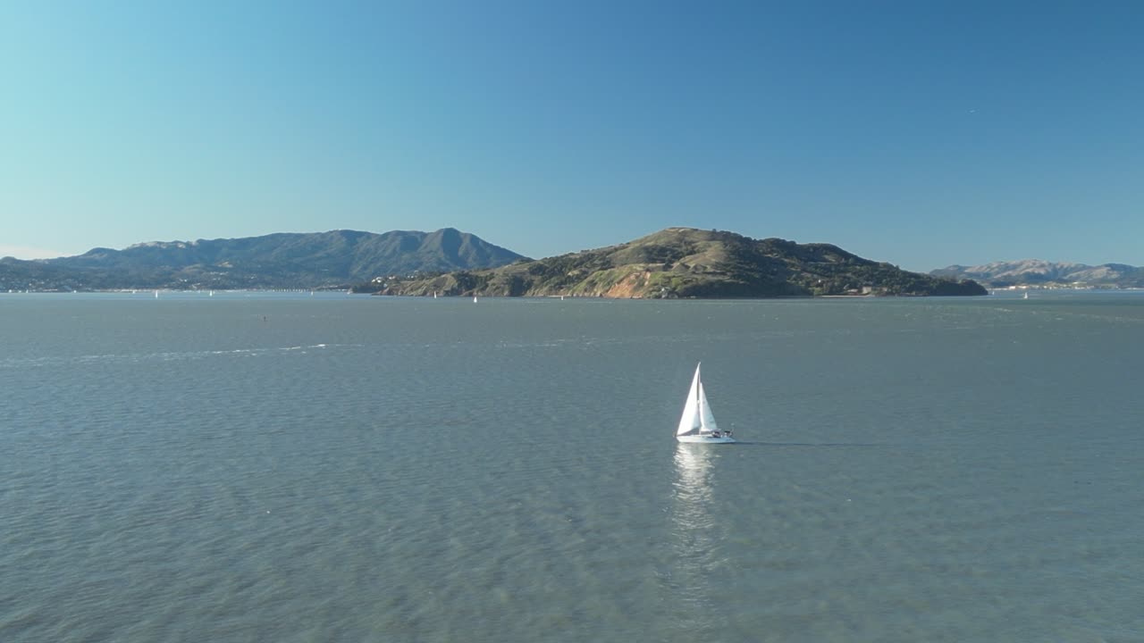 Pan drone shot of boat in the day on the North Pacific Ocean in California, USA