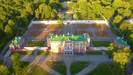 aerial view of kadriorg palace and its beautiful gardens, surrounded by lush green trees.