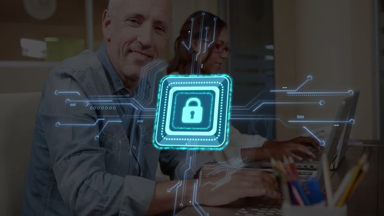Man and woman typing on laptops in office, displaying holographic lock icon enhancing cybersecurity