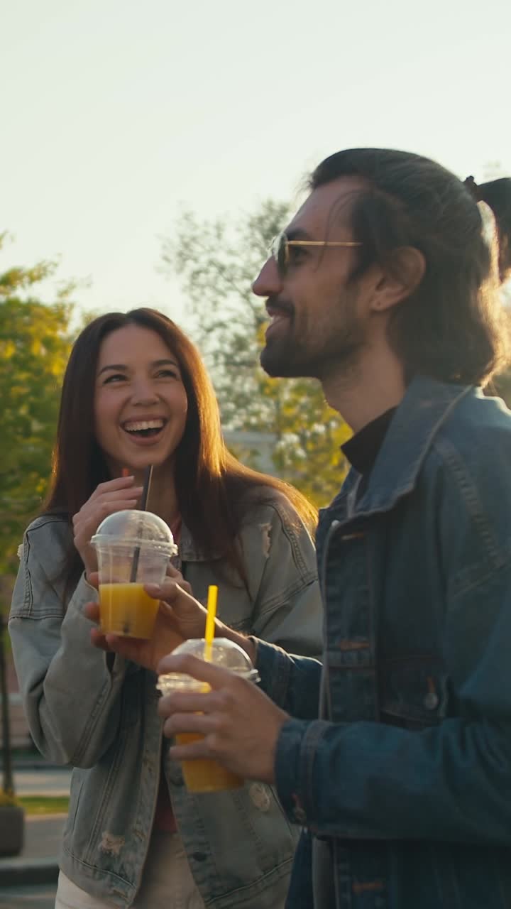Friends enjoying juice drinks outdoors