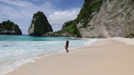 girl walking on the beach on nusa penida island in bali indonesia