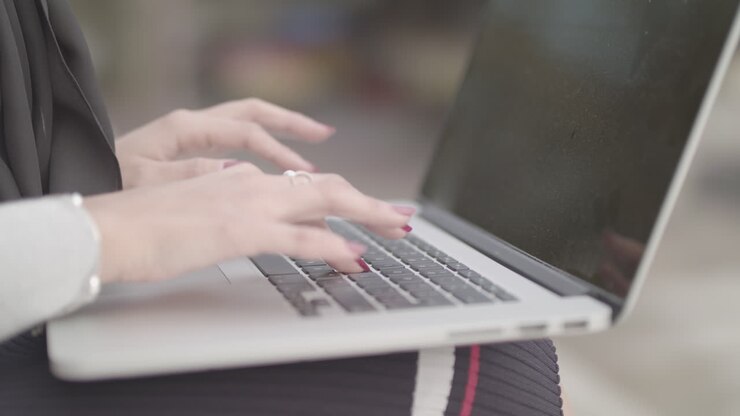 Close Up Shot Of Woman Typing On Keyboard Whilst Working Outside , In Slowmotion - Ungraded