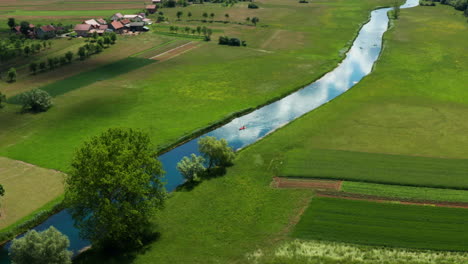 kayakers travel down gacka river, croatia