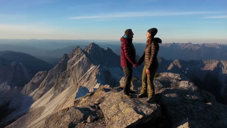 couple standing on a mountain peak with panoramic views