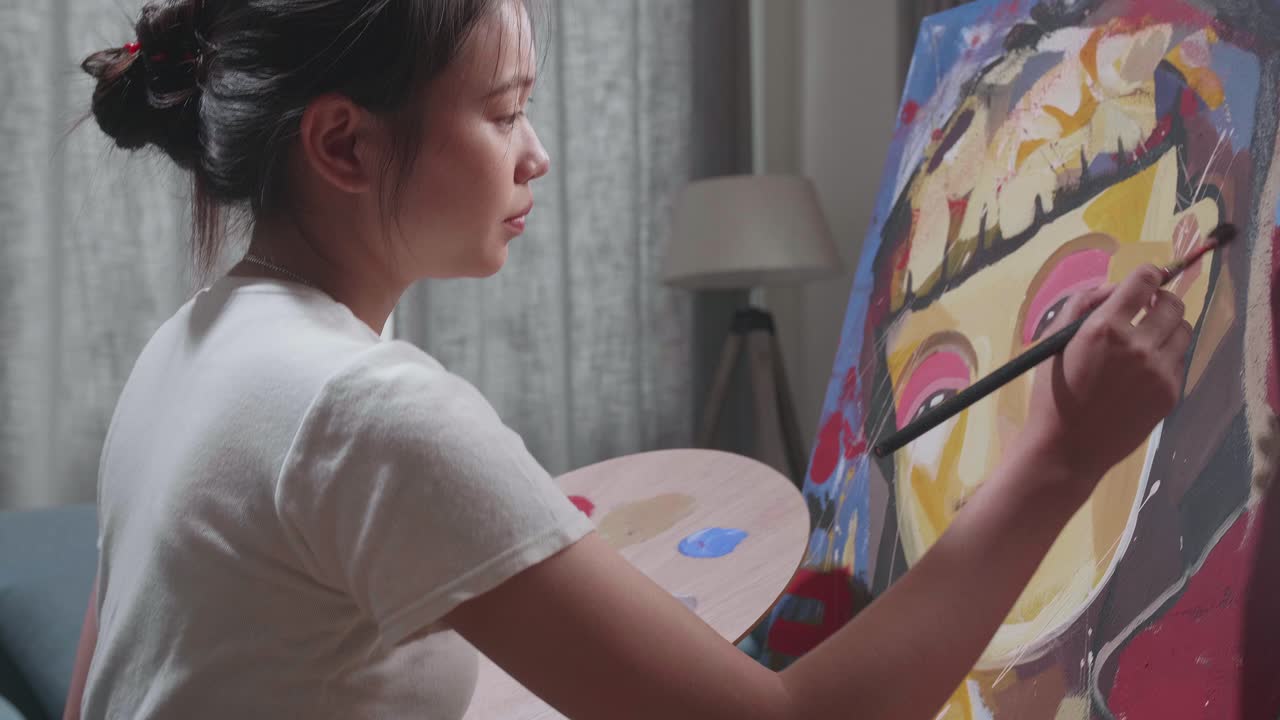 Woman painting a portrait at home