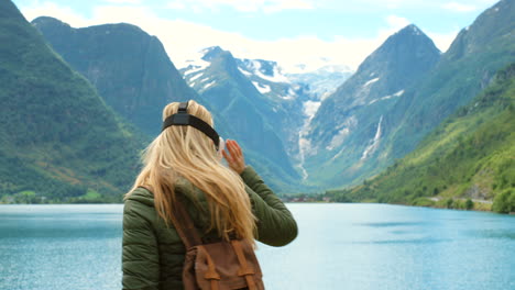 woman wearing vr headset in scenic norwegian fjord landscape