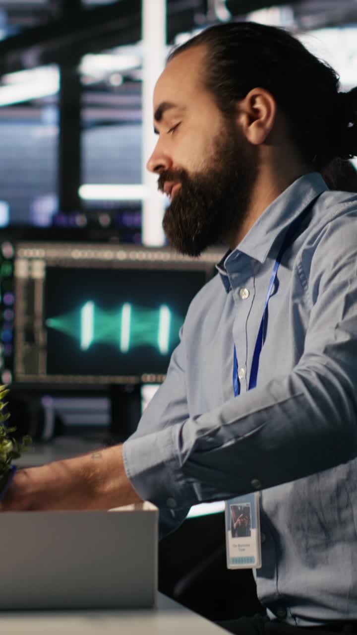 Vertical video Upset data center worker packing desk after being replaced by AI
