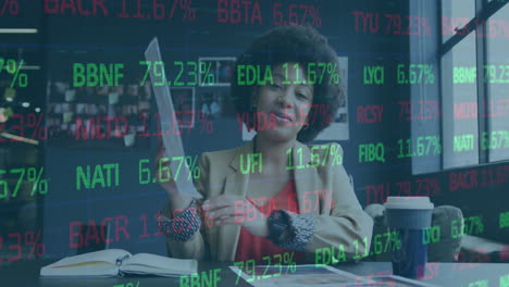 animation of financial data processing over african american businesswoman having a call in office