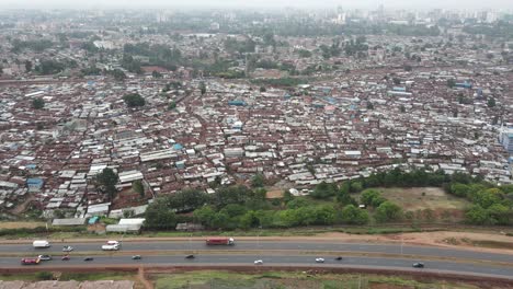 Aerial-View-of-Highway-Traffic-by-Kibera,-Nairobi,-Kenya