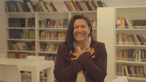 Happy-middle-aged-woman-expressing-love-with-hand-signals-to-camera,close-up