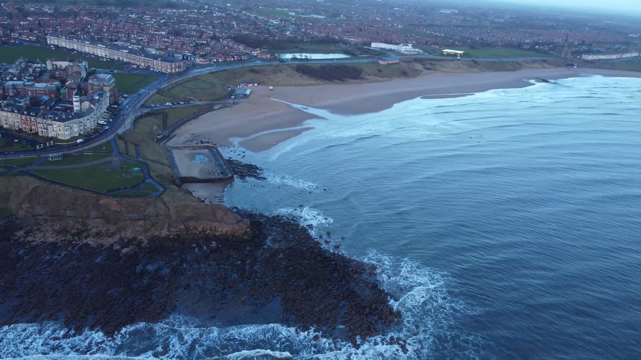 4K drone video overlooking Tynemouth Longsands beach and gentle waves - Newcastle