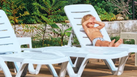 happy young boy by the pool.
