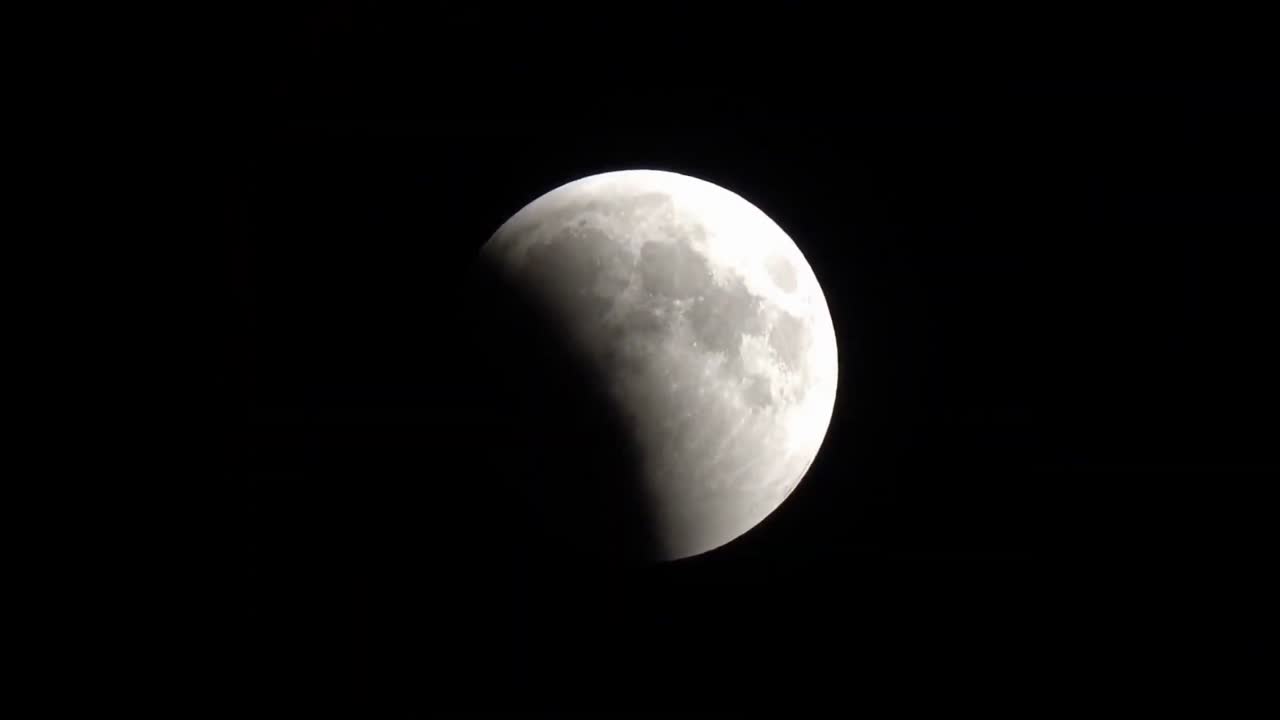 Lunar eclipse in progress against a dark sky.