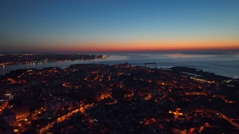 Drone-footage-from-flying-over-Almada-at-dawn,-just-before-sunrise