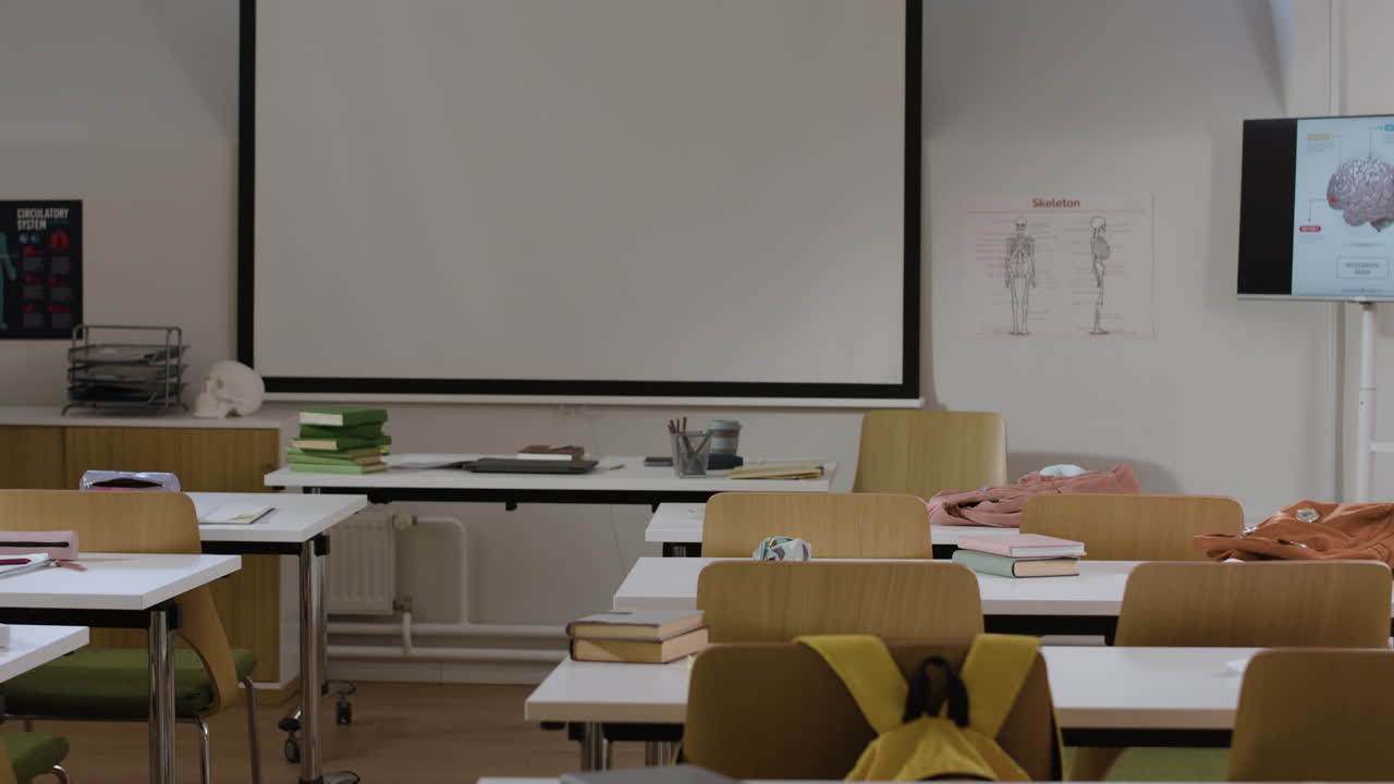Empty Classroom with Desks and Projector Screen