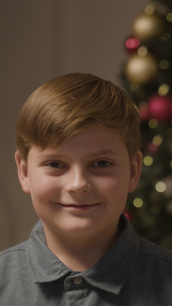 Boy in front of Christmas tree