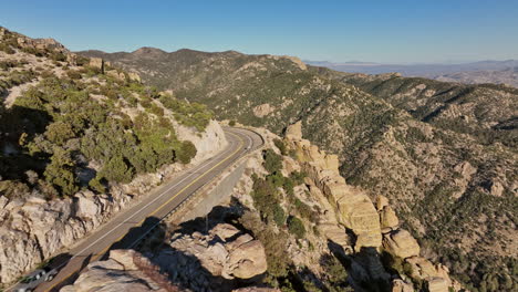 Mt-Lemmon-Arizona-Aerial-v8-flyover-Wind-Point-Vista-along-rocky-cliff-edge-of-Catalina-highway-capturing-spectacular-outback-landscape-with-Hitchcock-Pinnacle---Shot-with-Mavic-3-Cine---March-2022