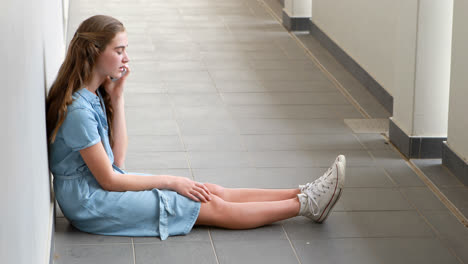 schoolgirl talking on mobile phone in corridor