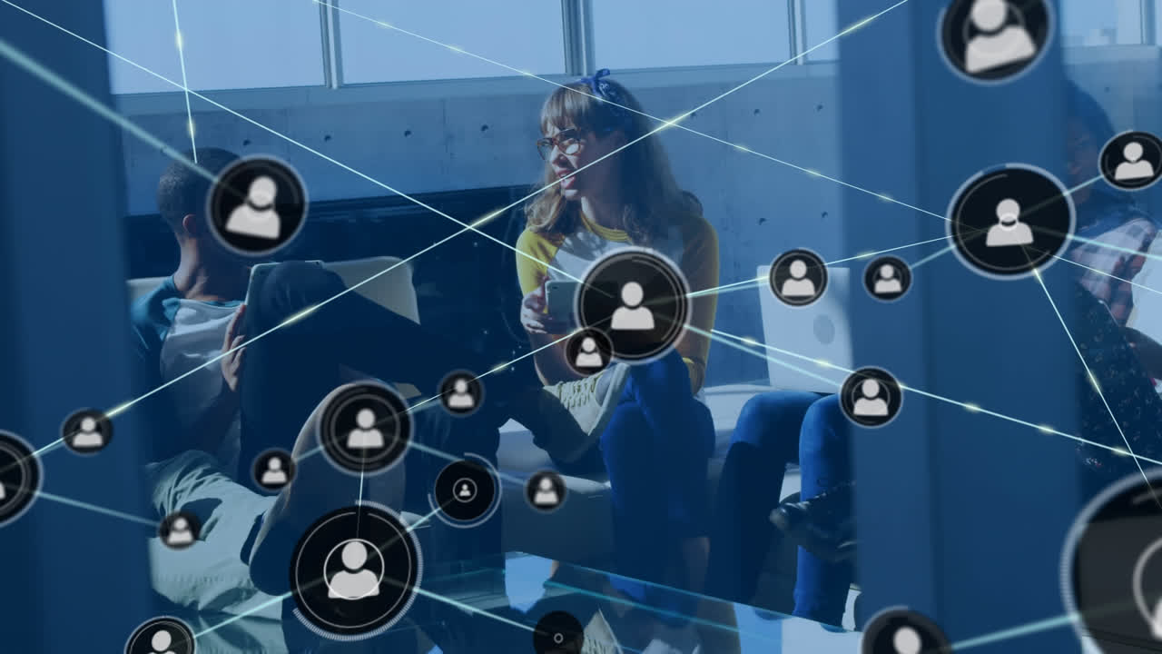 Animation of network of connections with icons over diverse business people having meeting at office