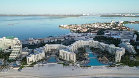 a luxury resort in cancun with pools, beach, and clear water, aerial view, playa delfines