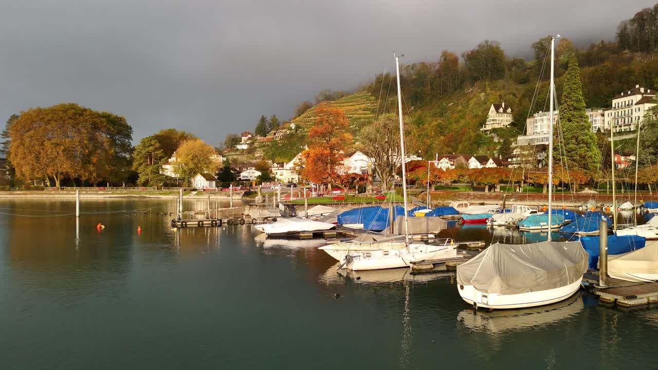 Beautiful Autumn Day at a Lakeside Village with Sailboats