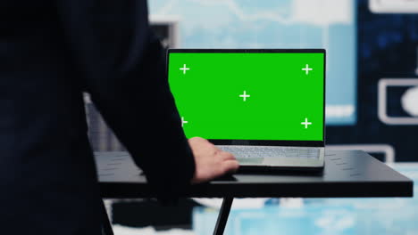 general director with a chroma key display reviewing performance metrics