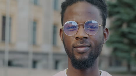 man wearing sunglasses in a city