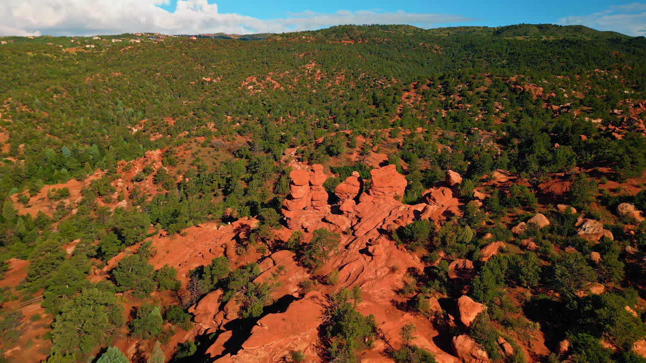 Sunlit territory of Bentonite Hills in Capitol Reef National Park, Utah, United States. Approaching red rounded rocks with a man standing in the center