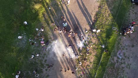 people celebrating graduation by dirtying the graduate