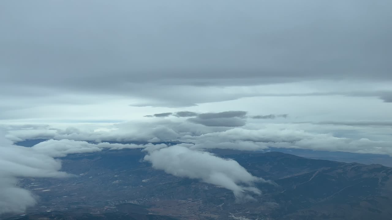 Dramatic winter sky, a pilots&rsquo; point of view in a real flight, full of snow clouds