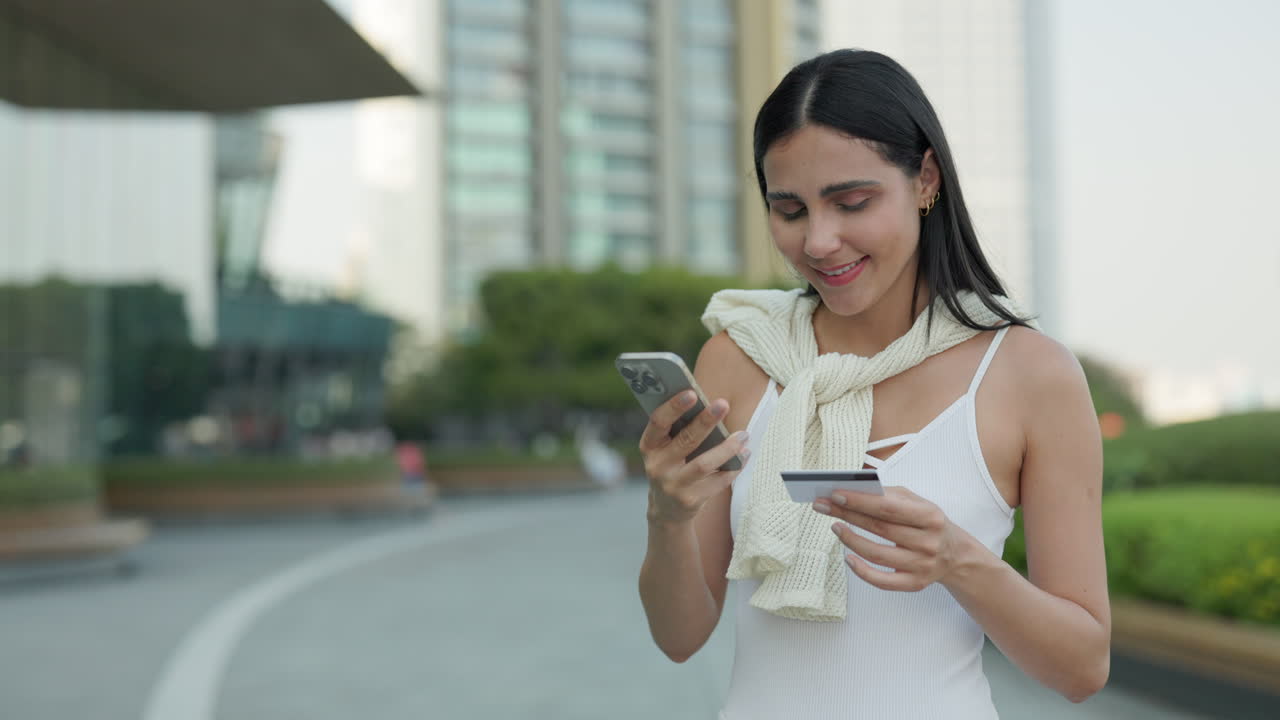 Young Woman Shopping Online with Mobile Phone and Credit Card