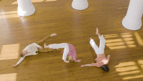 top view of multiethnic group of contemporary dancers dancing and moving around the studio 1