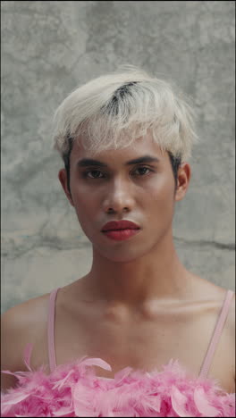 portrait of a person with pink feathers and white hair
