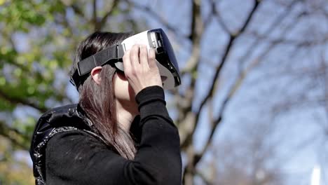 Serious-woman-in-VR-headset-in-park