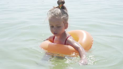 child swims sea inflatable ring. danger of drowning safety equipment, child life buoy