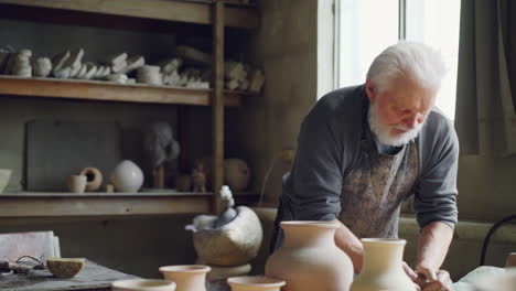 senior potter working in studio