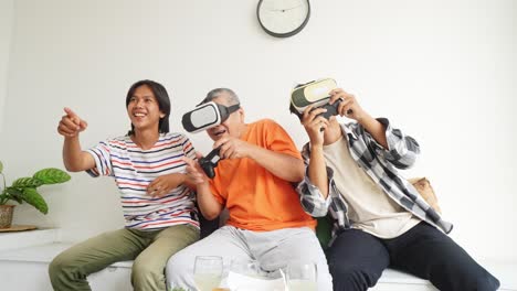 happy asian father and son wearing vr glasses and playing video games together