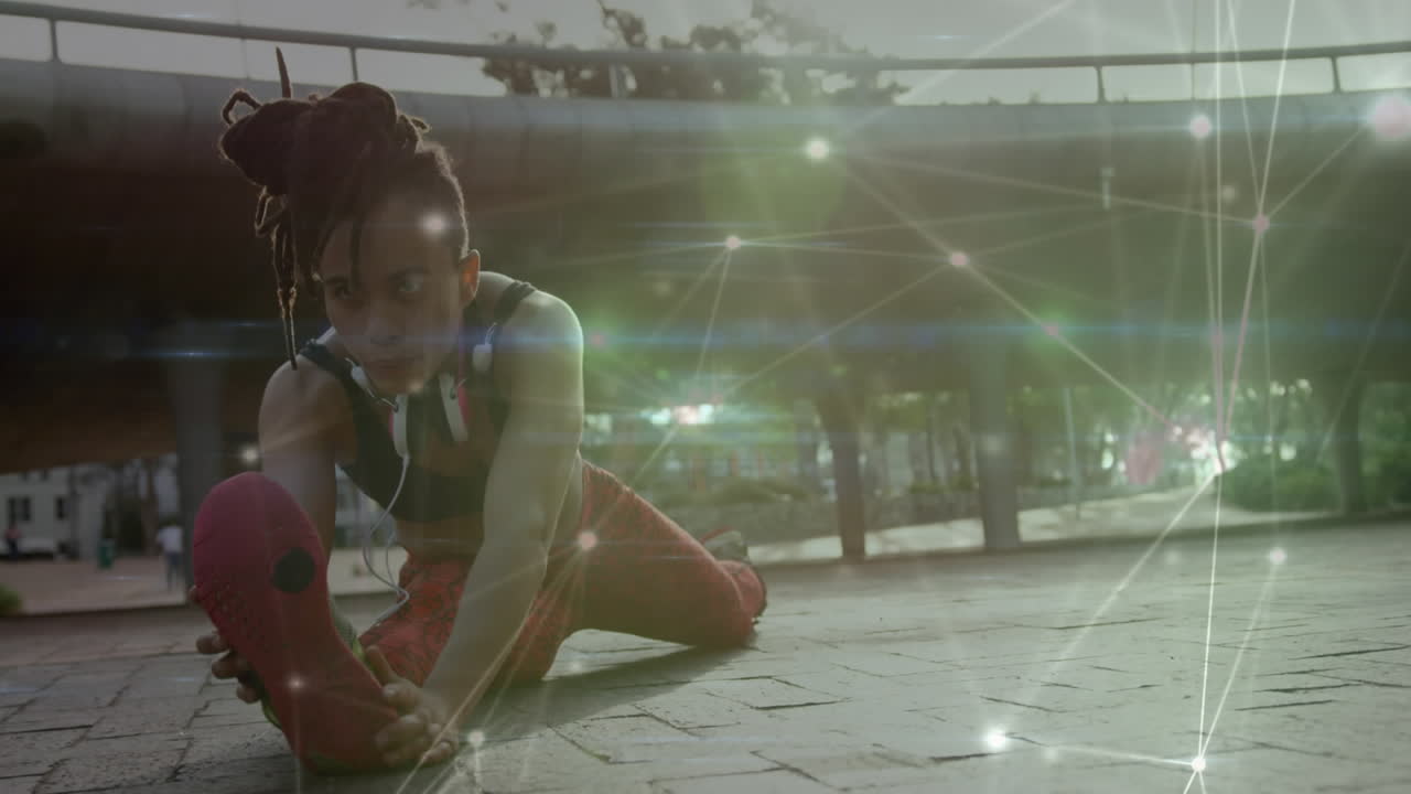 red de conexiones contra una mujer afroamericana que realiza ejercicios de estiramiento en el parque