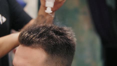 Close-Up-view-of-a-hairdresser-applying-powder-to-the-head-of-his-customer-in-barber-shot.-Stylish-professional-haircut-for-the