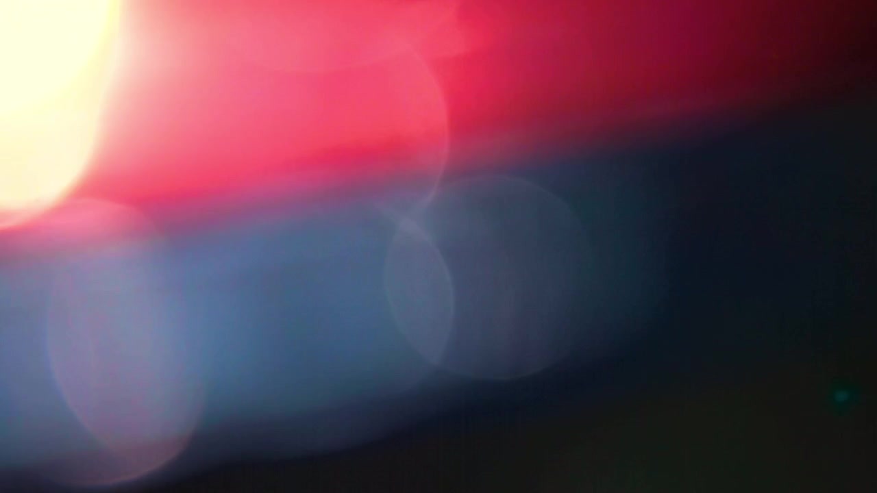 Abstract Light Leaks and Bokeh Effects on Dark Background