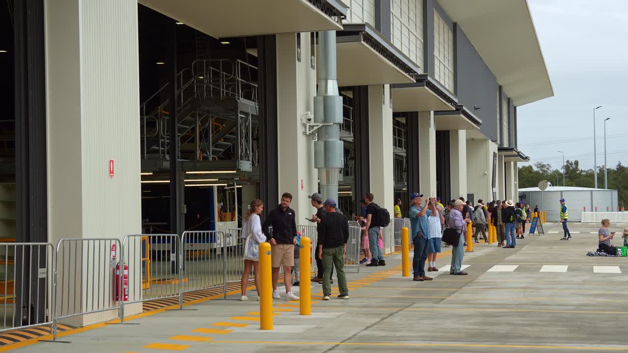 People Waiting at a Modern Bus Depot
