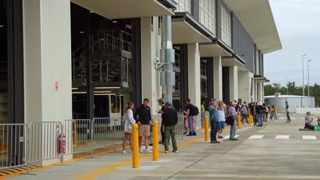 people waiting at a modern bus depot