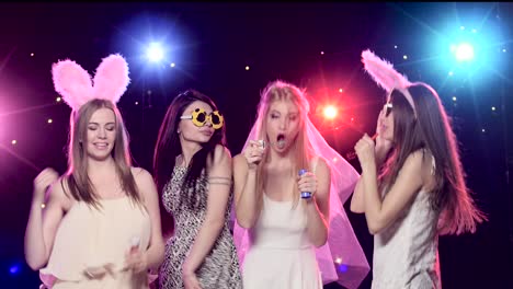 Women partying and singing karaoke