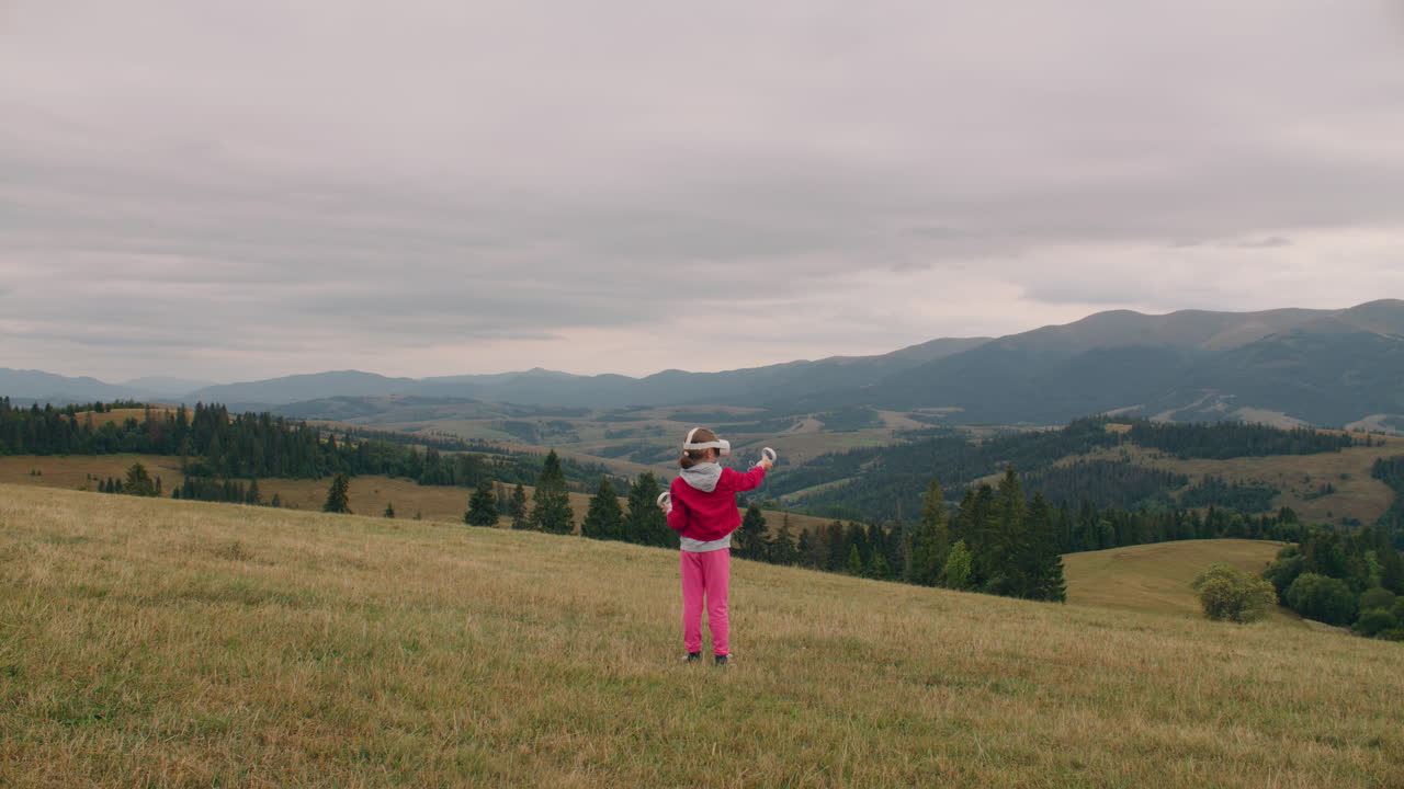 Child wearing VR headset enjoying mountain view